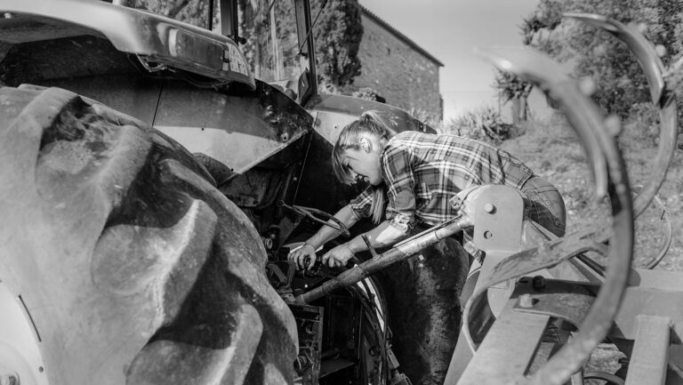 focused farmer repairing tractor in countryside du 2025 01 09 12 16 31 utc in category